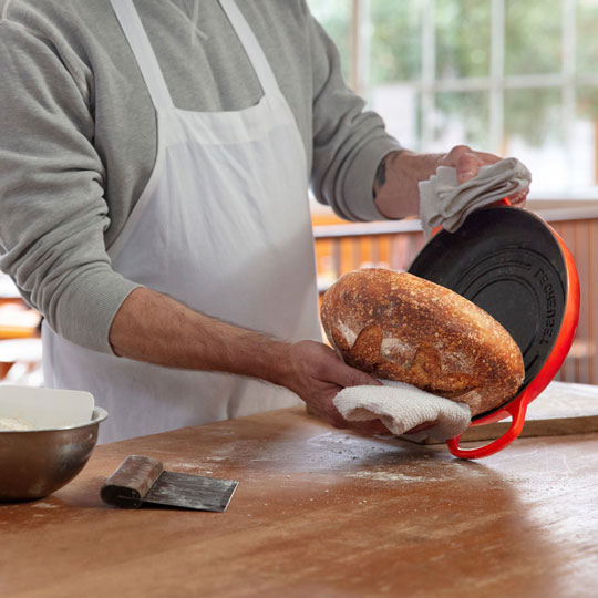 Chad Robertson tips bread out of a Le Creuset bread oven