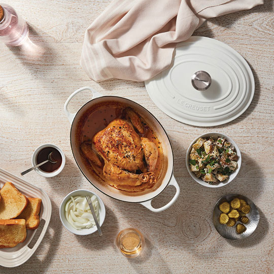 whole roasted chicken in an oval dutch oven