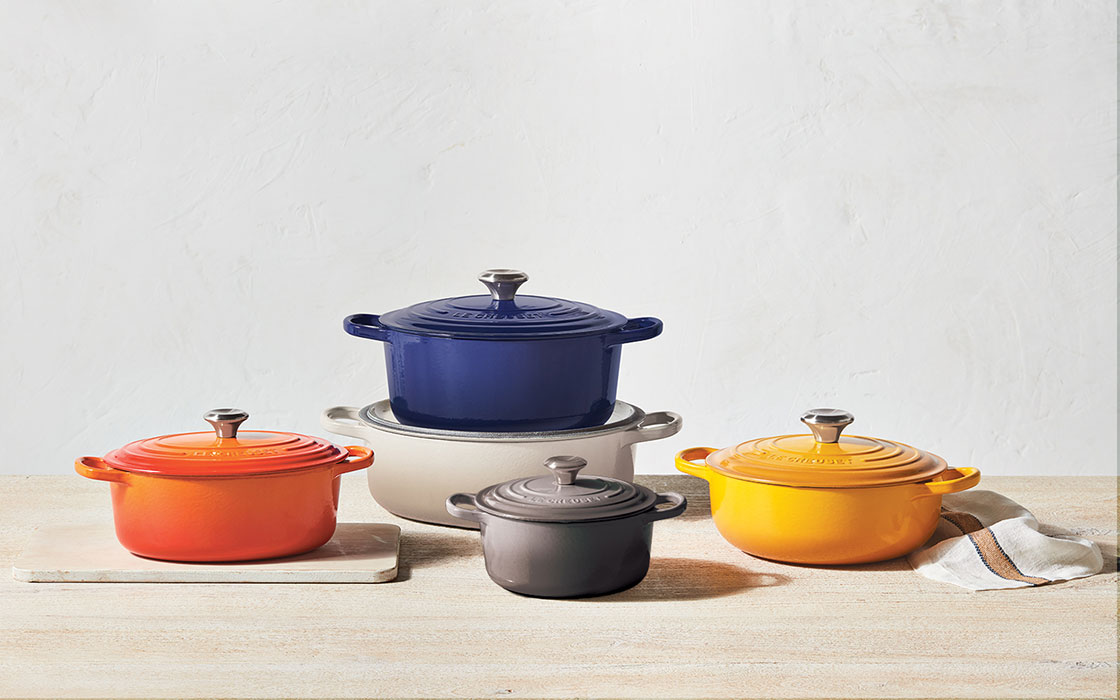 assorted dutch ovens in various shapes, colors and sizes