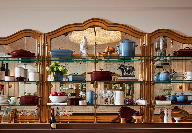 elegant shelves filled with decor and cookware in wine red and light blue